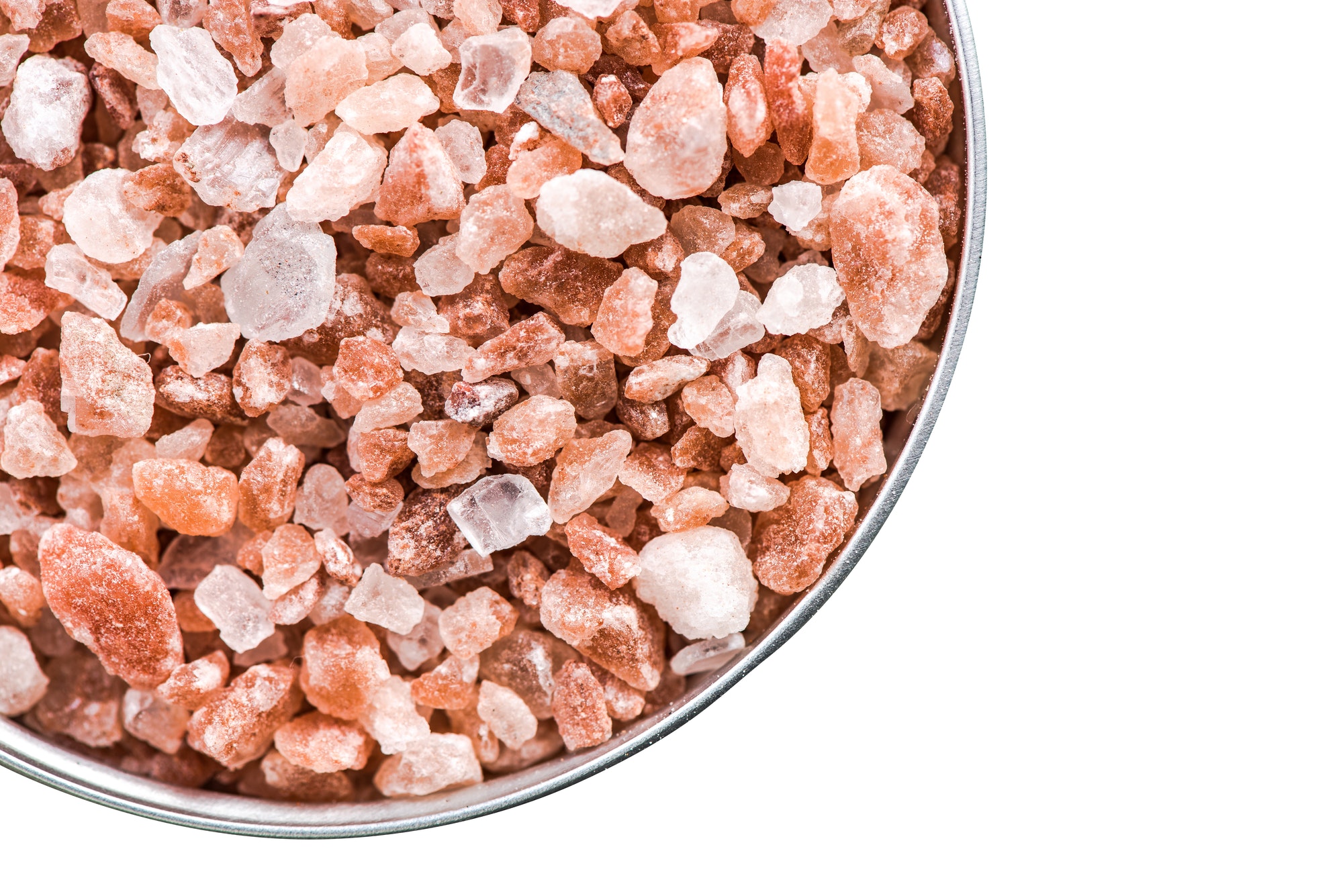 Himalayan salt cristals seeds in pot isolated on white