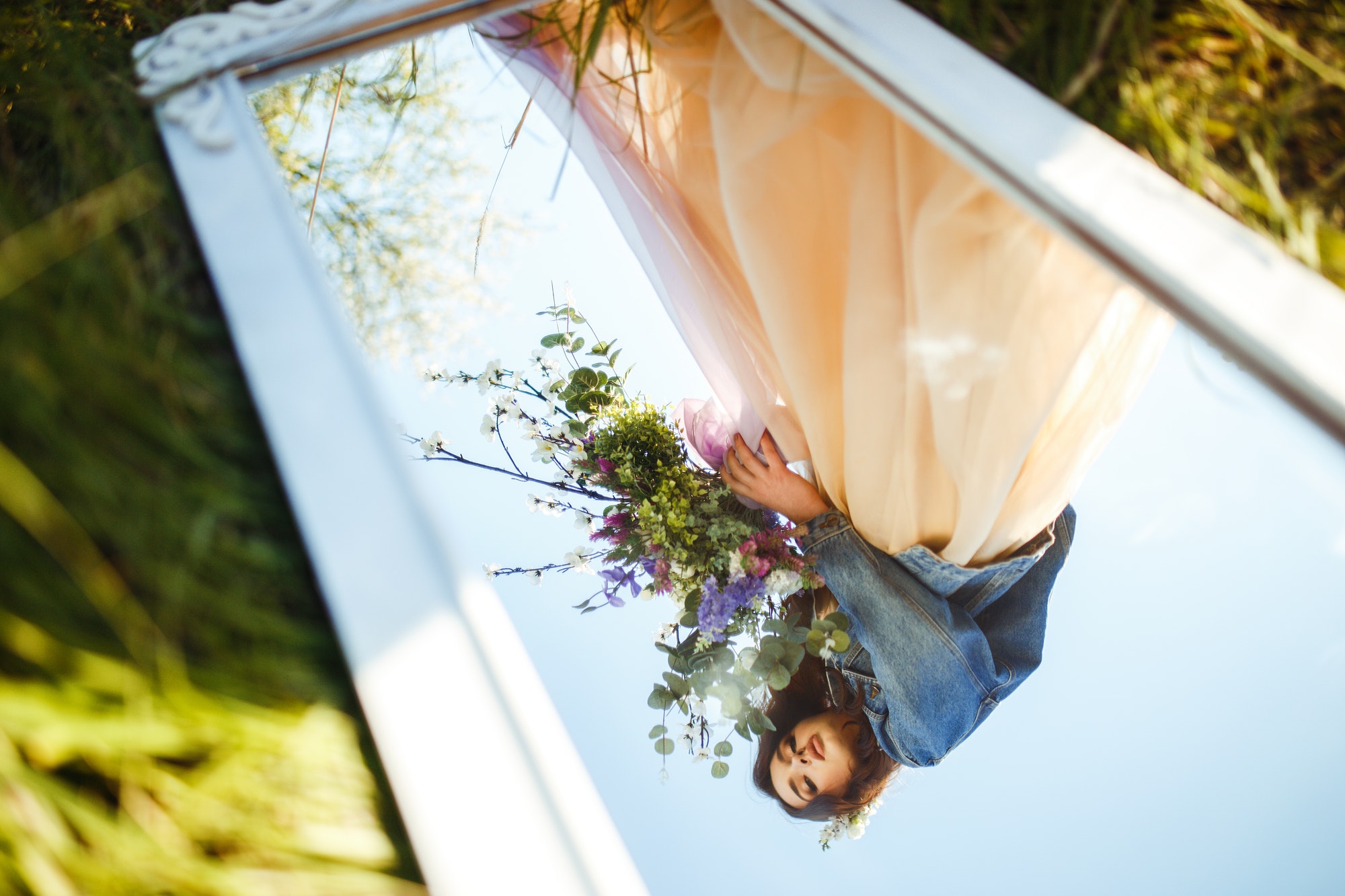 Portrait of a beautiful bride through mirror. Wedding concept. Stylish wedding. Great sunset light.