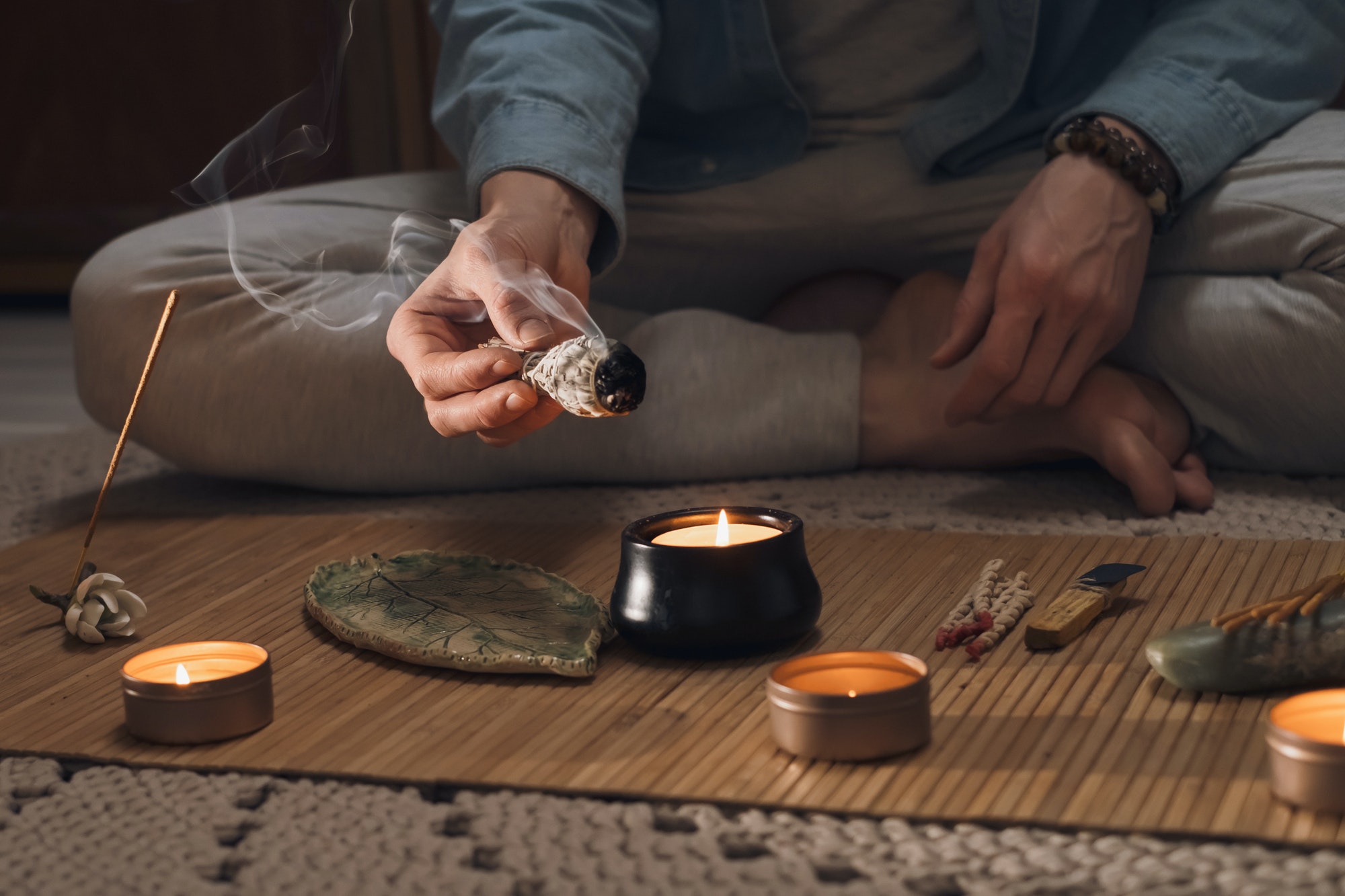 Man lighting incense for meditation and spiritual practice