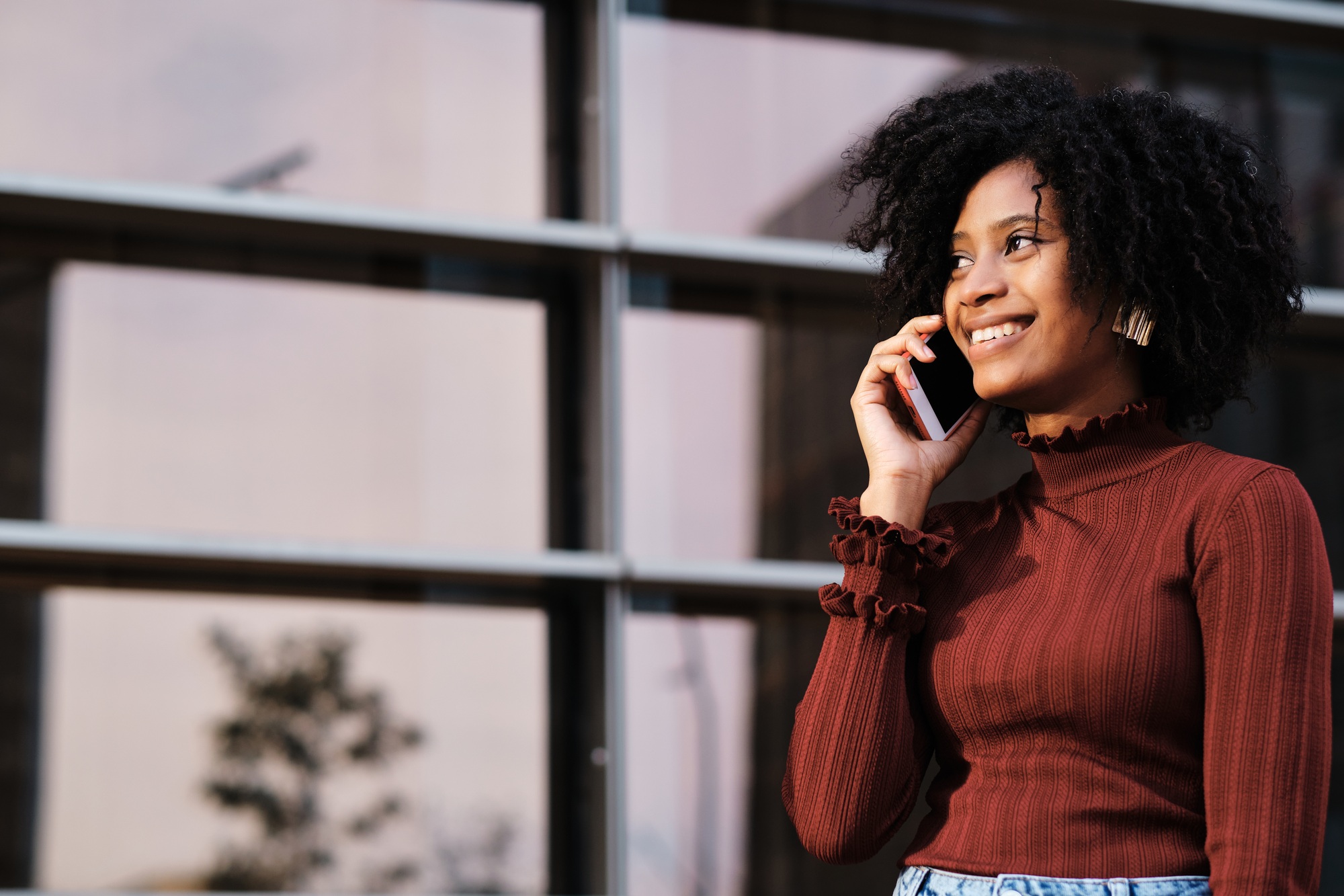 Business woman talking on phone outdoors.